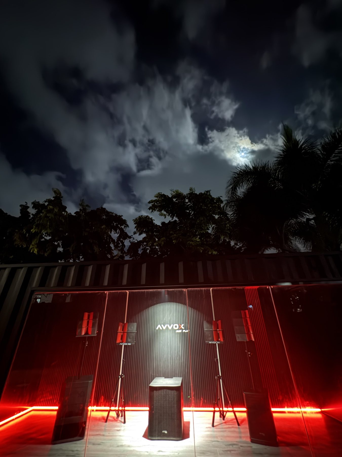 AVVOX showroom container at night with red light along the floor