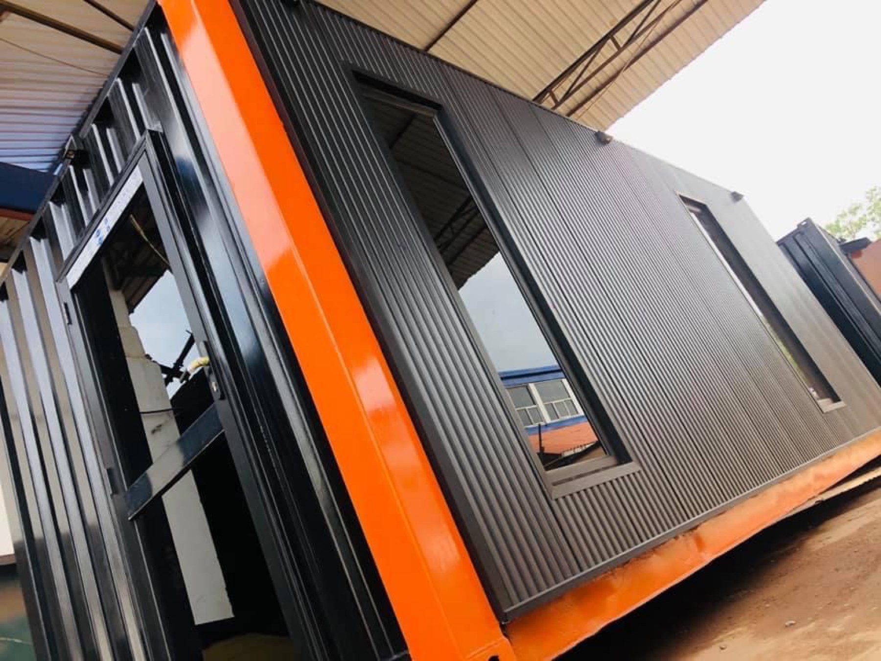 Orange and black container unit in the fabrication yard